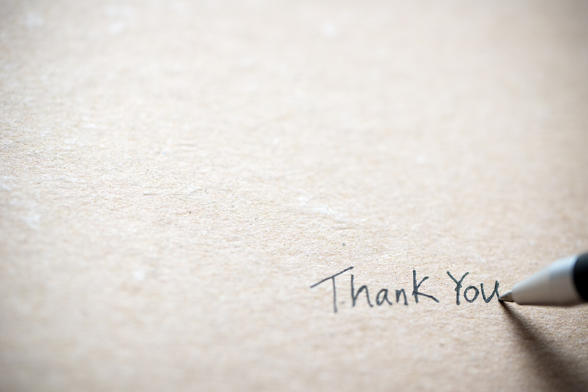 photo of handwritten thank you on textured paper