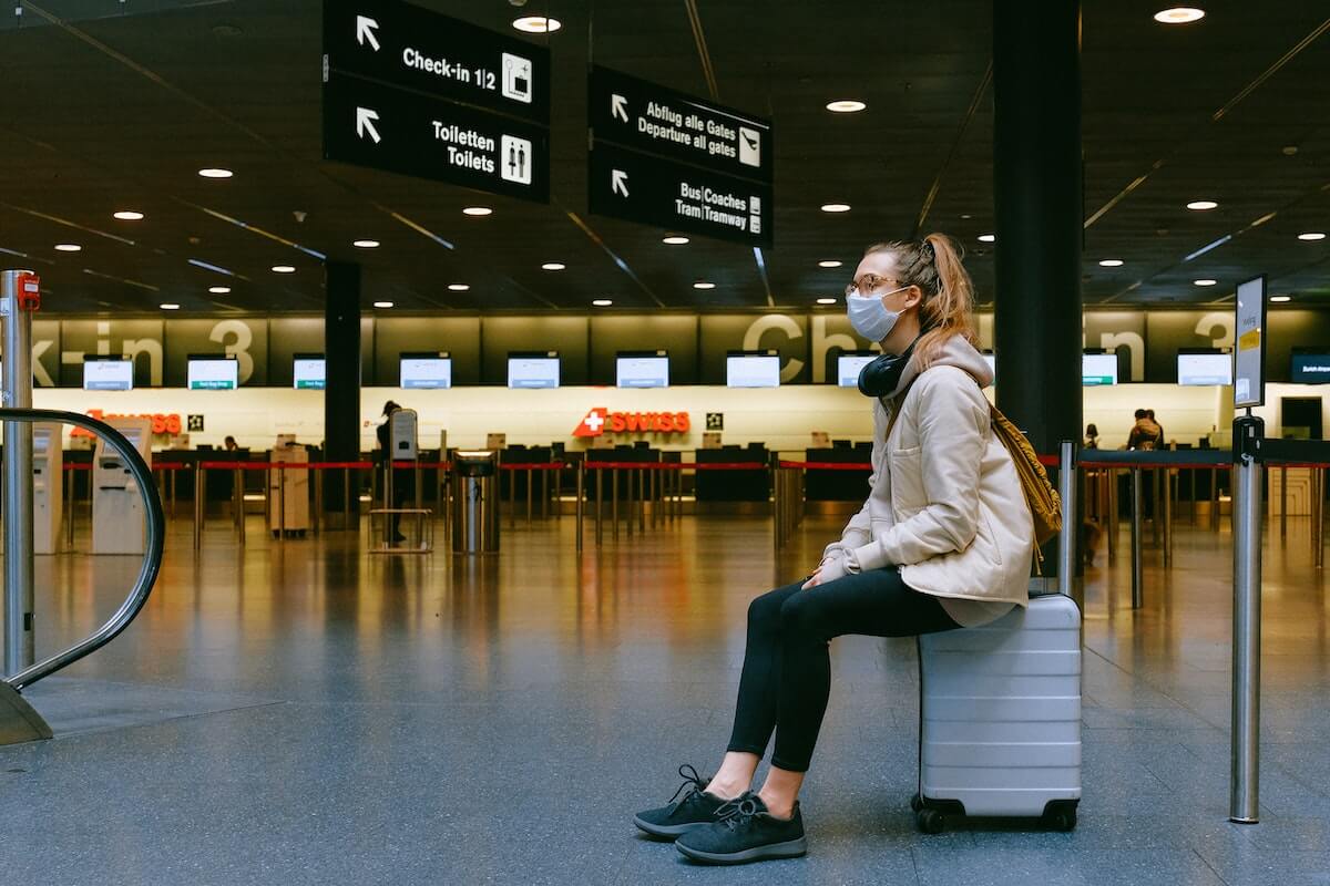 Photo of a woman traveling with a mask on 