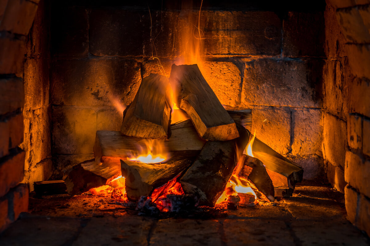 Photo of Wood burning in a cozy fireplace at home
