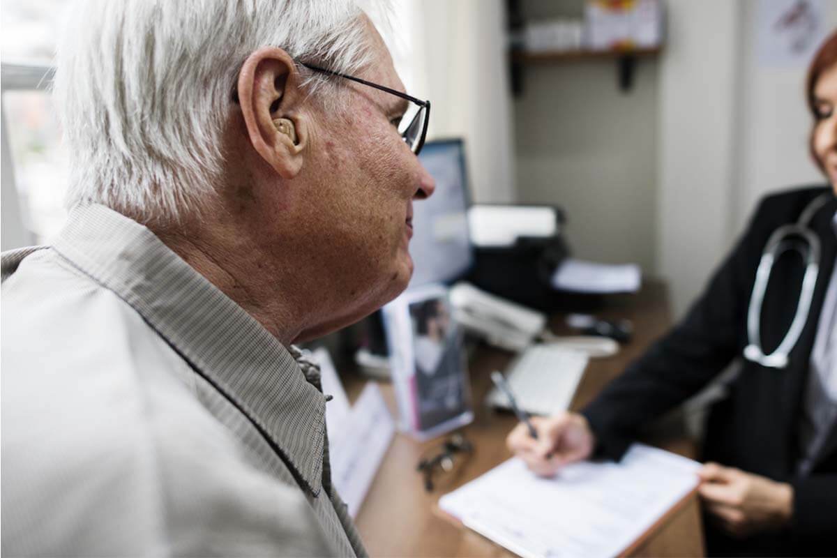 Photo of elderly man with a physician