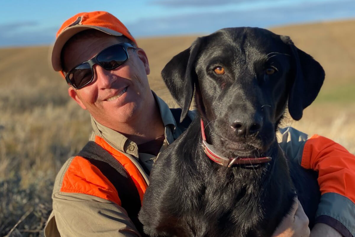 Photo of Richard Jolkovsky, MD with his dog while hunting