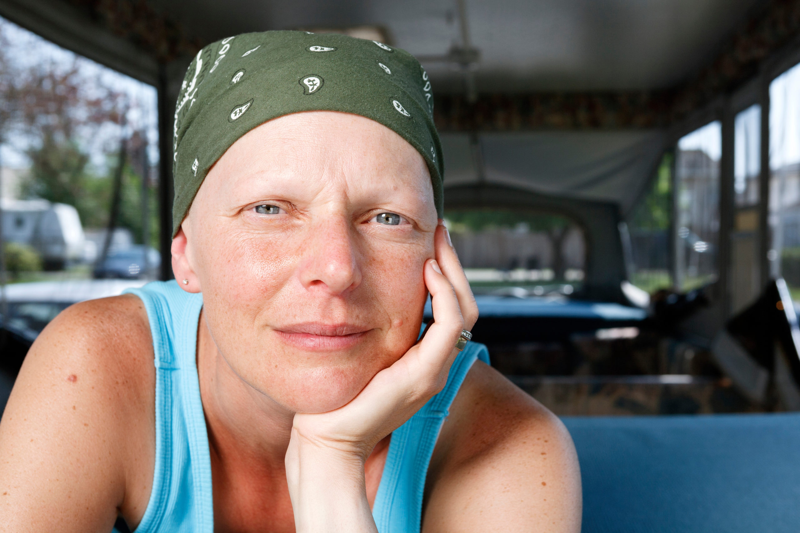 Portrait of a middle-aged woman fighting breast cancer and wearing a bandana.