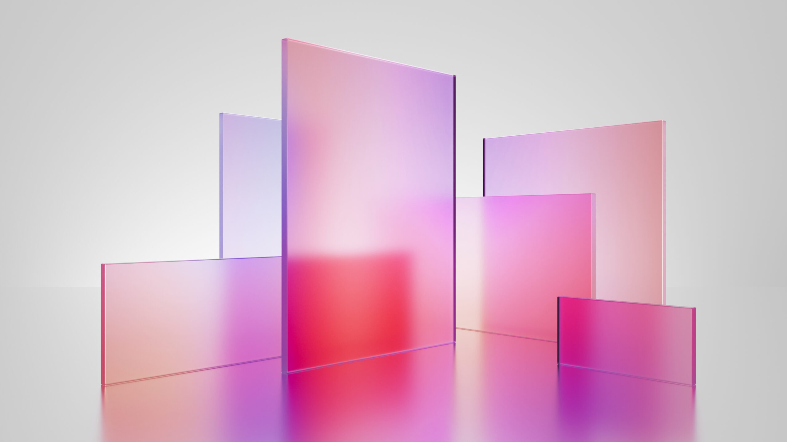 Graphic with translucent tiles in pink red violet gradient, simple square shapes representing the Learn content