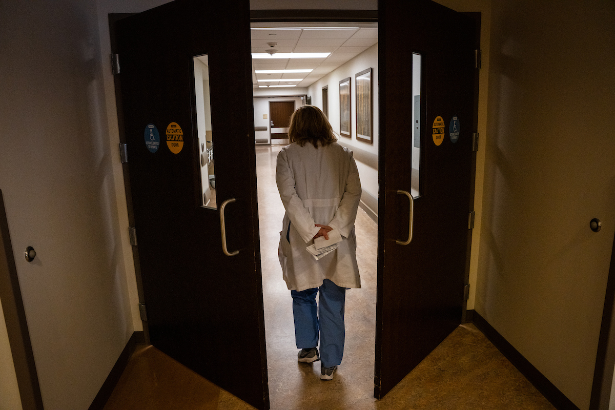 Photo of a physician walking through doors in the St. Cloud Hospital