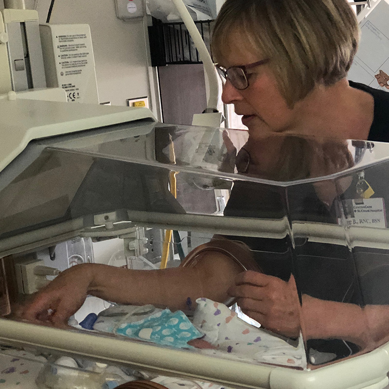 Photo of a nurse caring for a baby in the NICU