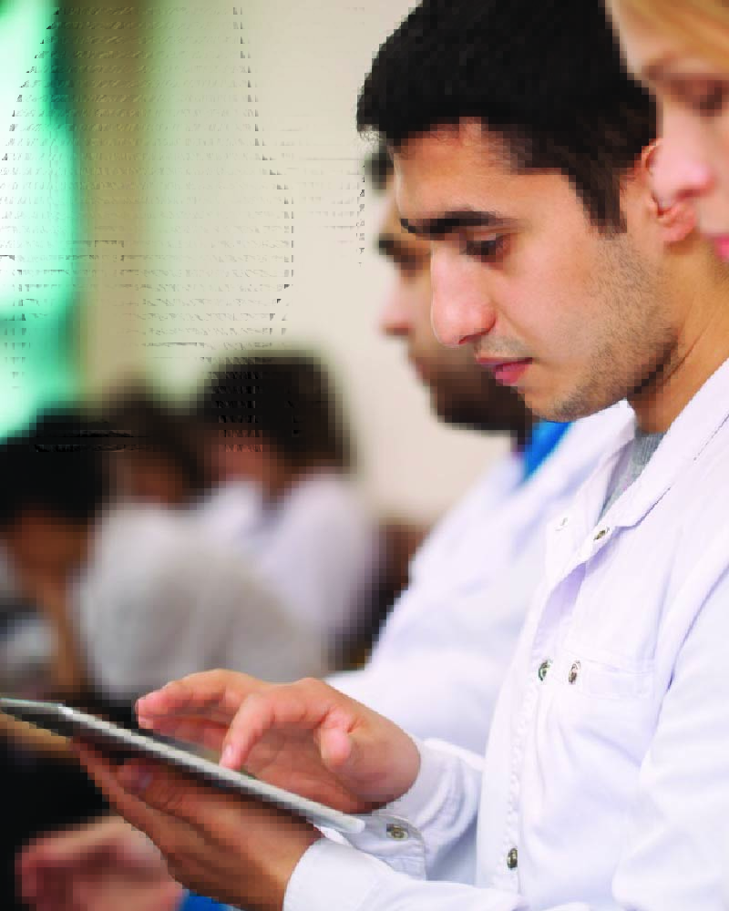 Photo of a medical student looking at a tablet