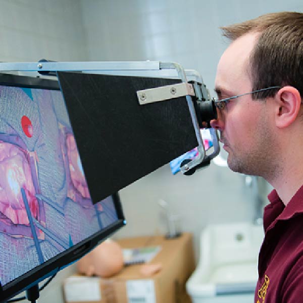 Photo of a University of Minnesota Medical School student using technology