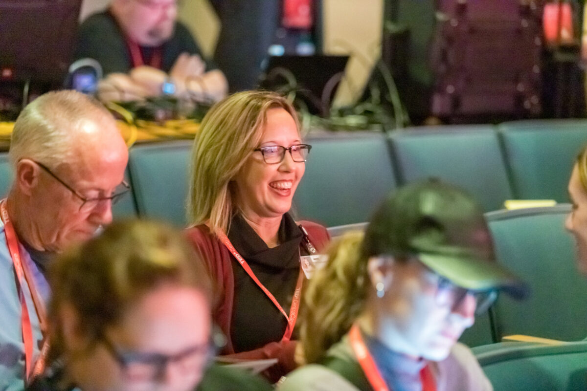 A TEDxCentraCare audience member smiling