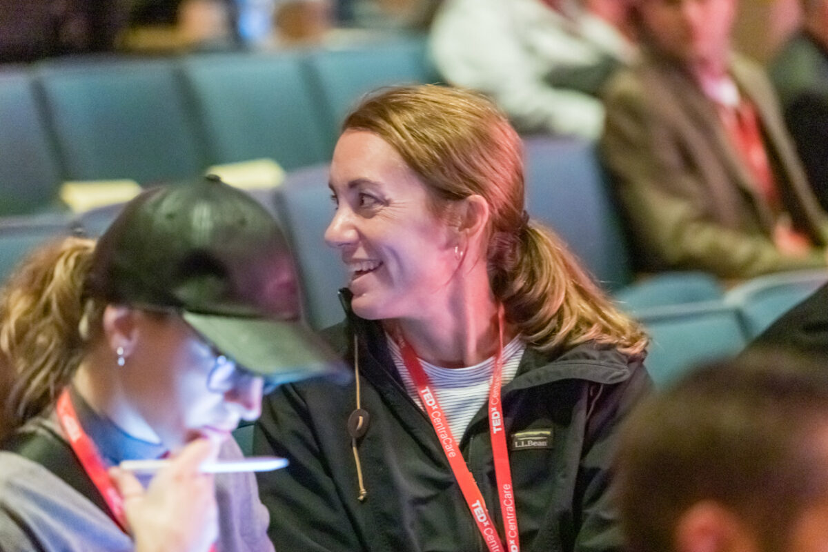 TEDxCentraCare attendees chatting in the Hoppe Auditorium