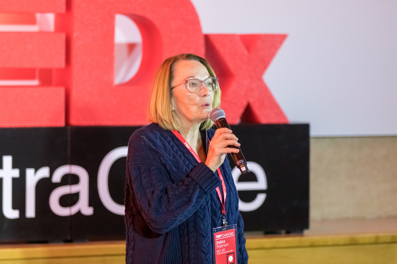 Debra Peterson, MD, one of the hosts of TEDxCentraCare, addresses the audience as the conclusion of the first half