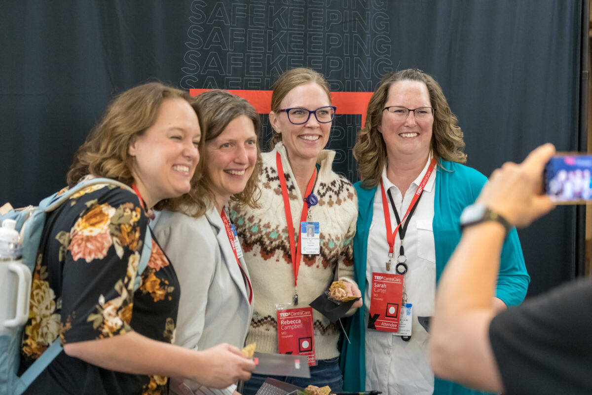 Colleagues gather for a photo at TEDxCentraCare reception