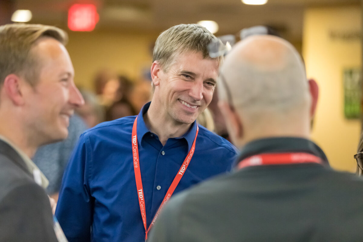 TEDxCentraCare speaker, Chris Thompson, MD, talks with colleagues