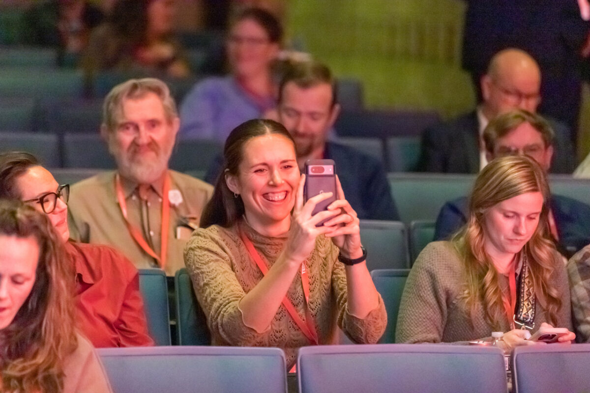 Photo of a TEDxCentraCare audience member taking a photo