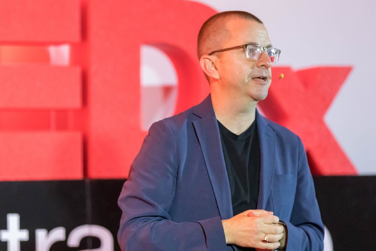 Photo of Andrew Olson, MD, on the TEDxCentraCare stage