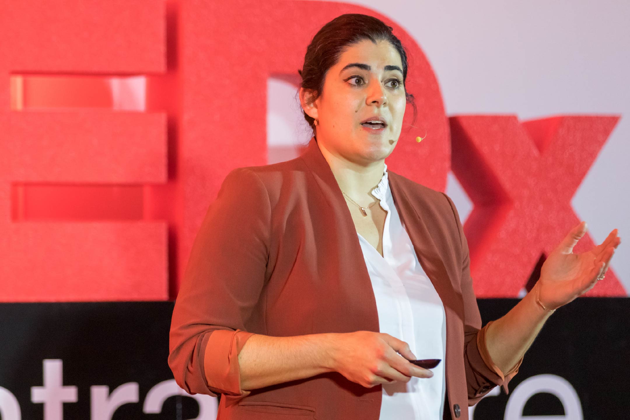 Photo of Claire Drom, MD, on the TEDxCentraCare stage