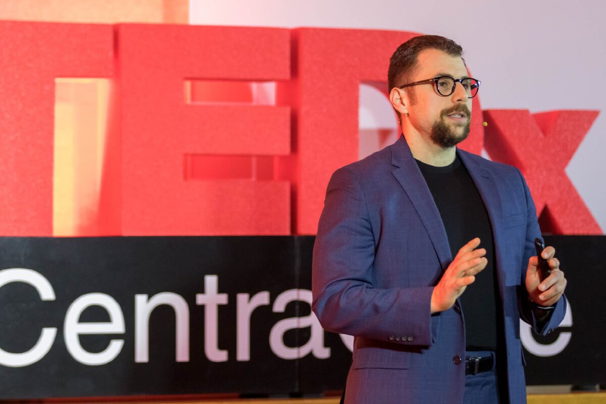 Photo of Fateh Bazerbachi, MD, on the TEDxCentraCare stage