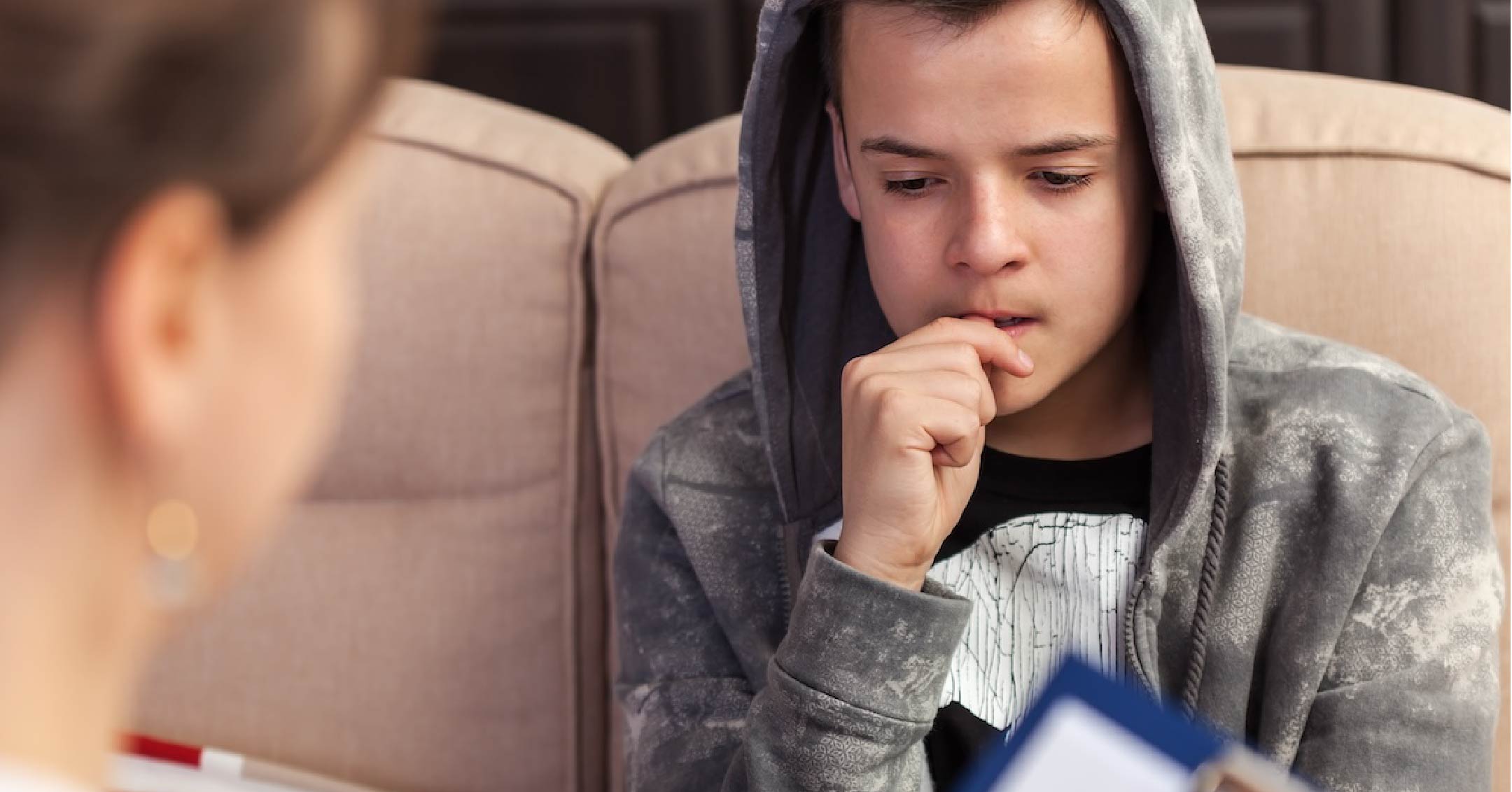 Photo of a young boy in a psychiatry session