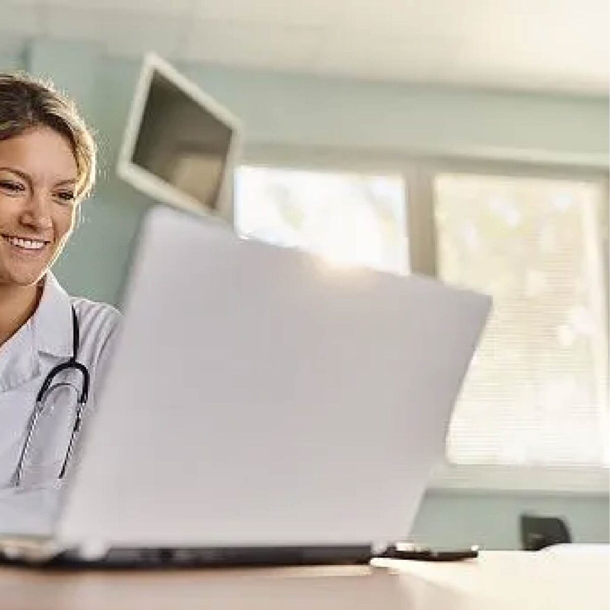 Photo of a female clinician at a computer