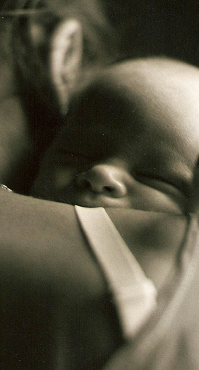 Over the shoulder photo of a mother holding her infant baby